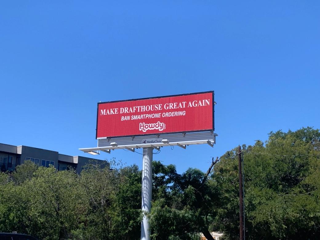 A red billboard that says "Make Drafthouse Great Again."