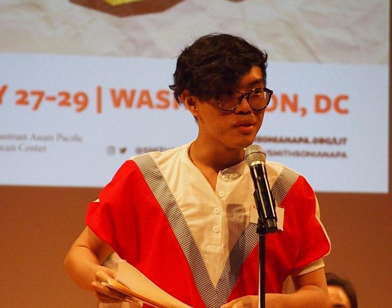 A person reading in front of a microphone at the Asian American Literature Festival, Washington, D.C.