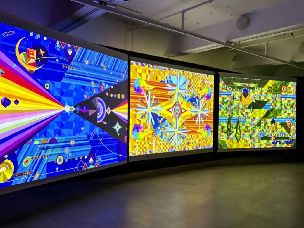 Three screens with bright, colorful geometric art.
