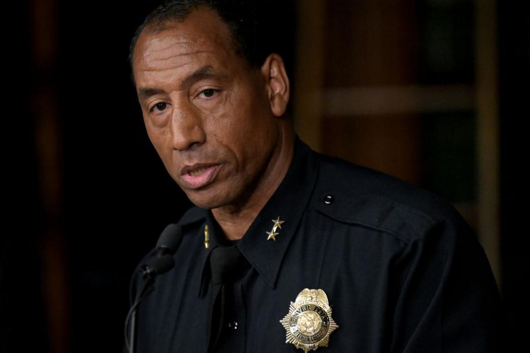 Denver Police Chief Ron Thomas, wearing his police uniform, speaks into a microphone during a press conference.