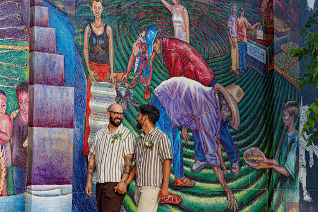 Two men next to a mural wall in Salt Lake’s west side.
