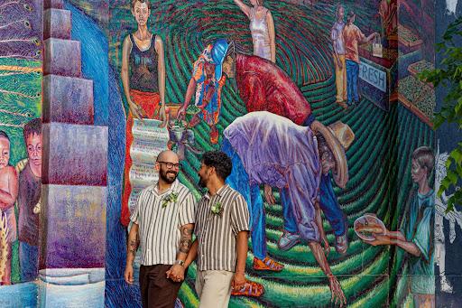 Two men next to a mural wall in Salt Lake’s west side.