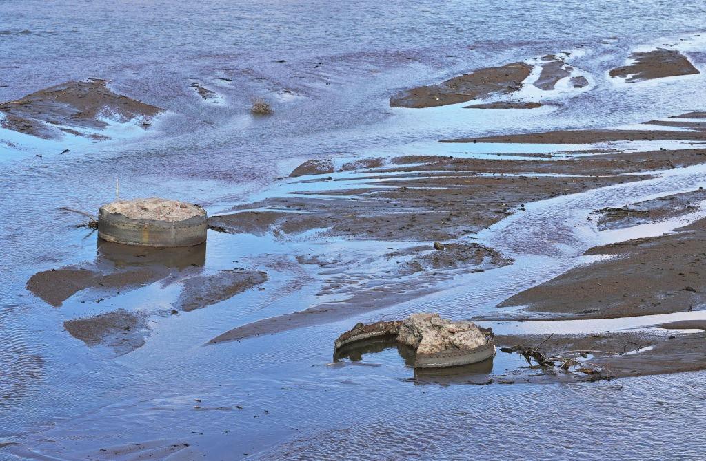 closeup image of concrete chunks and mud in the Arkansas River near Pueblo, Colorado.