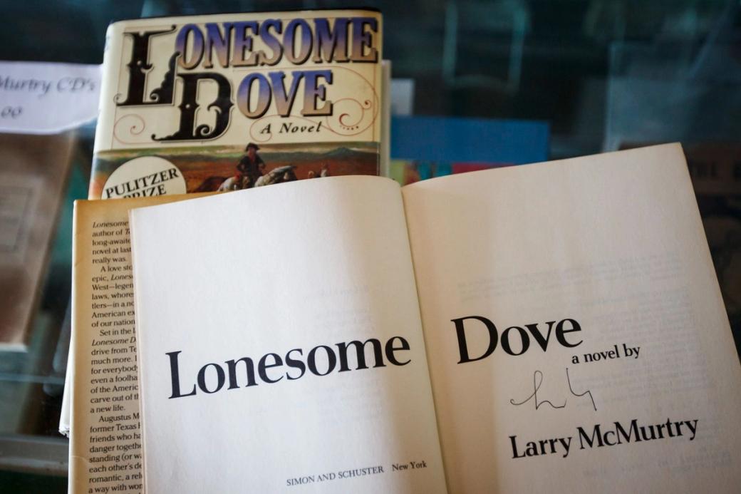 Two copies of the book "Lonesome Dove" are displayed and one is open to the title page.