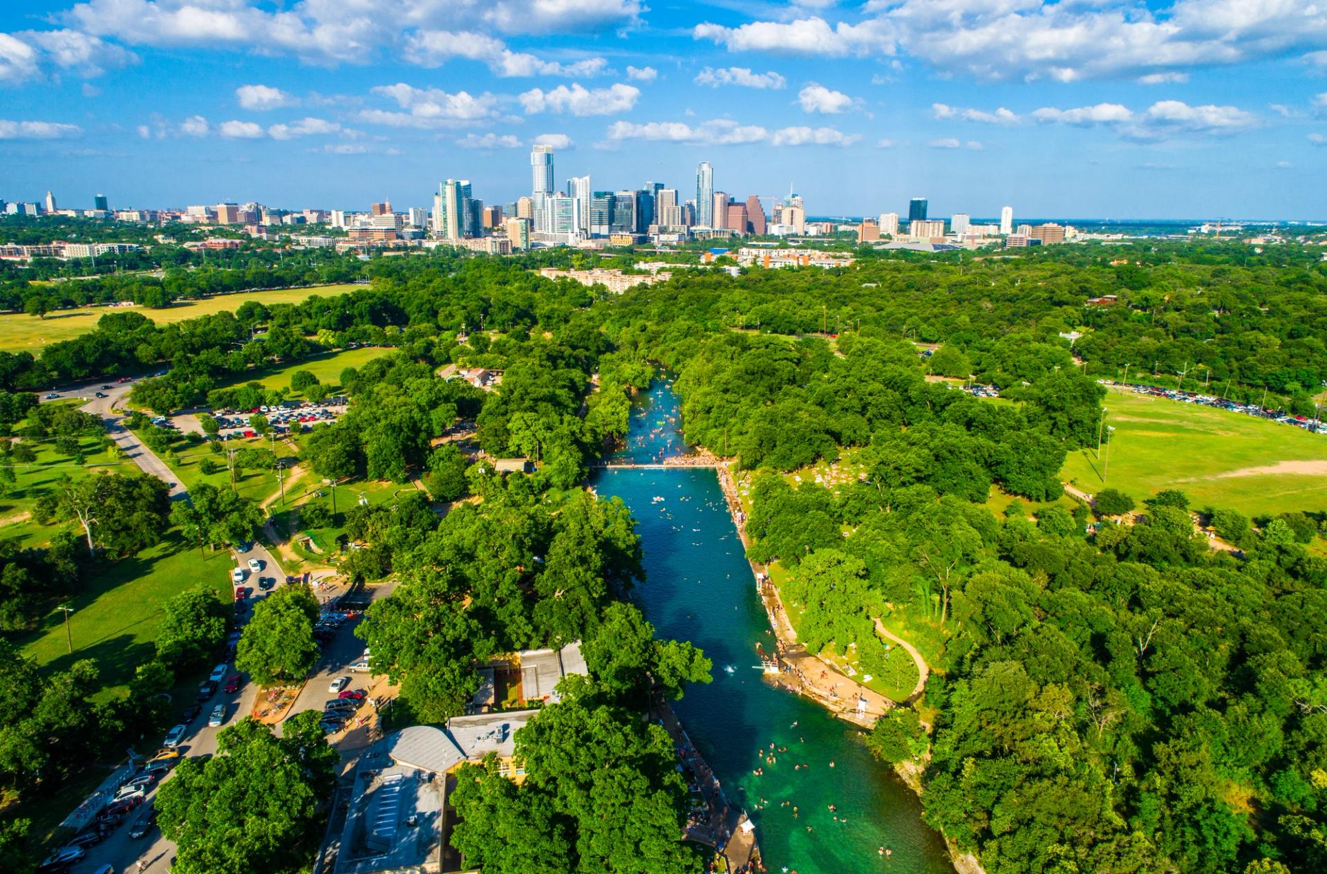 An aerial view of Barton Springs Pool and downtown Austin.