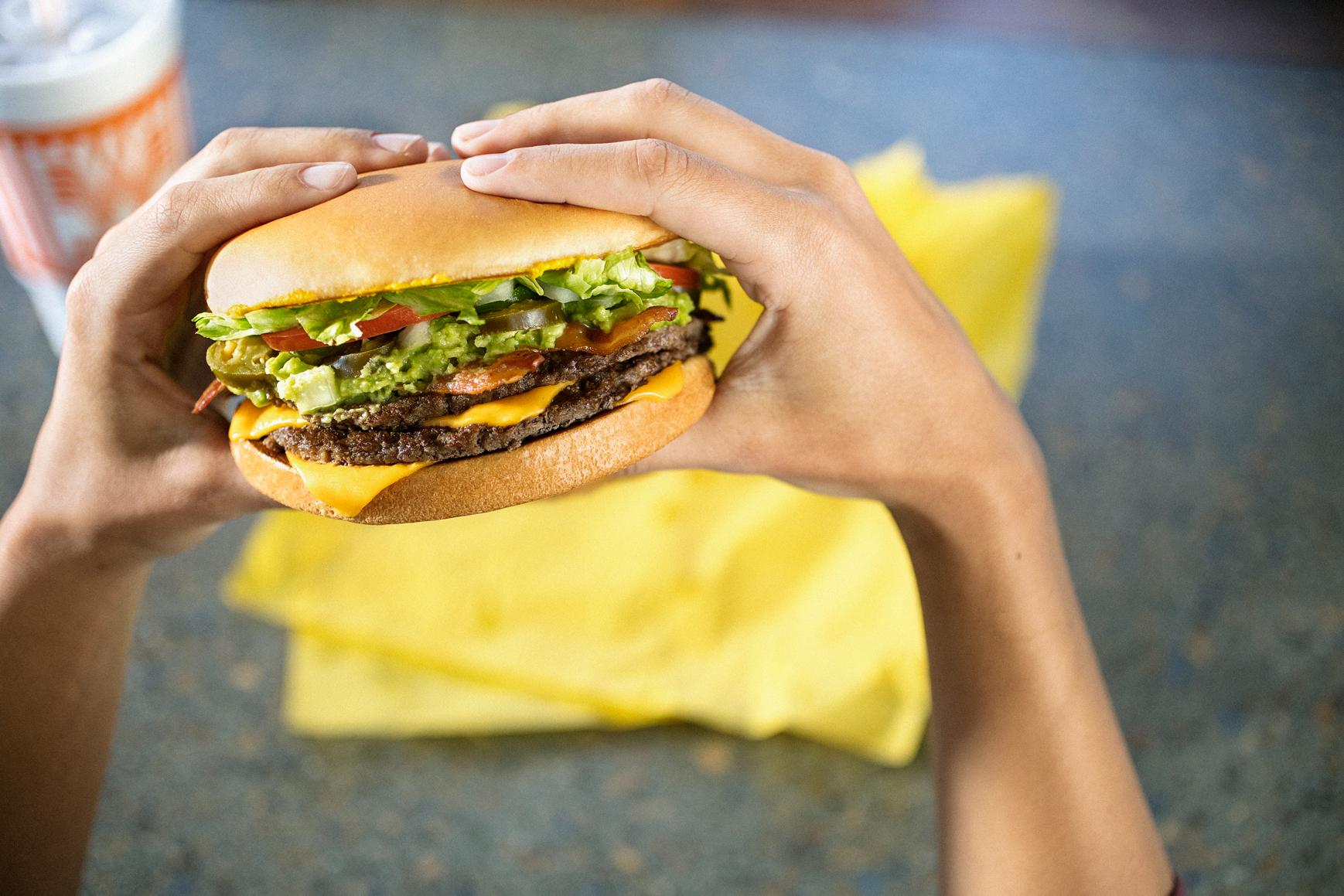 Photo of hands holding a Whataburger