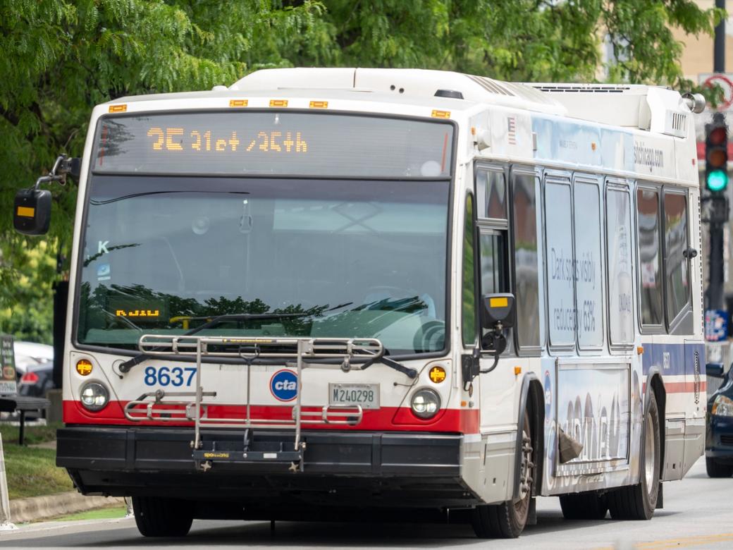 A bus driving on the road on a sunny day