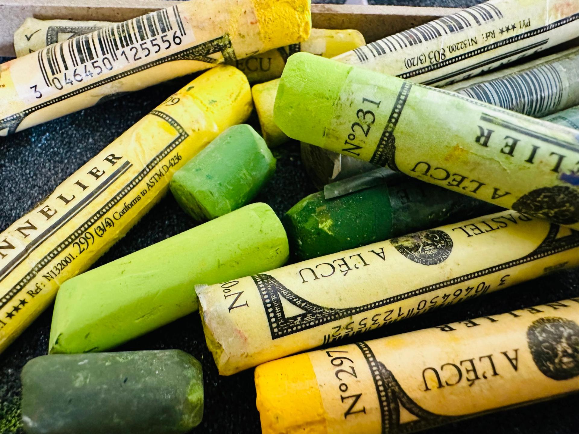A pile of giant green and yellow crayons.