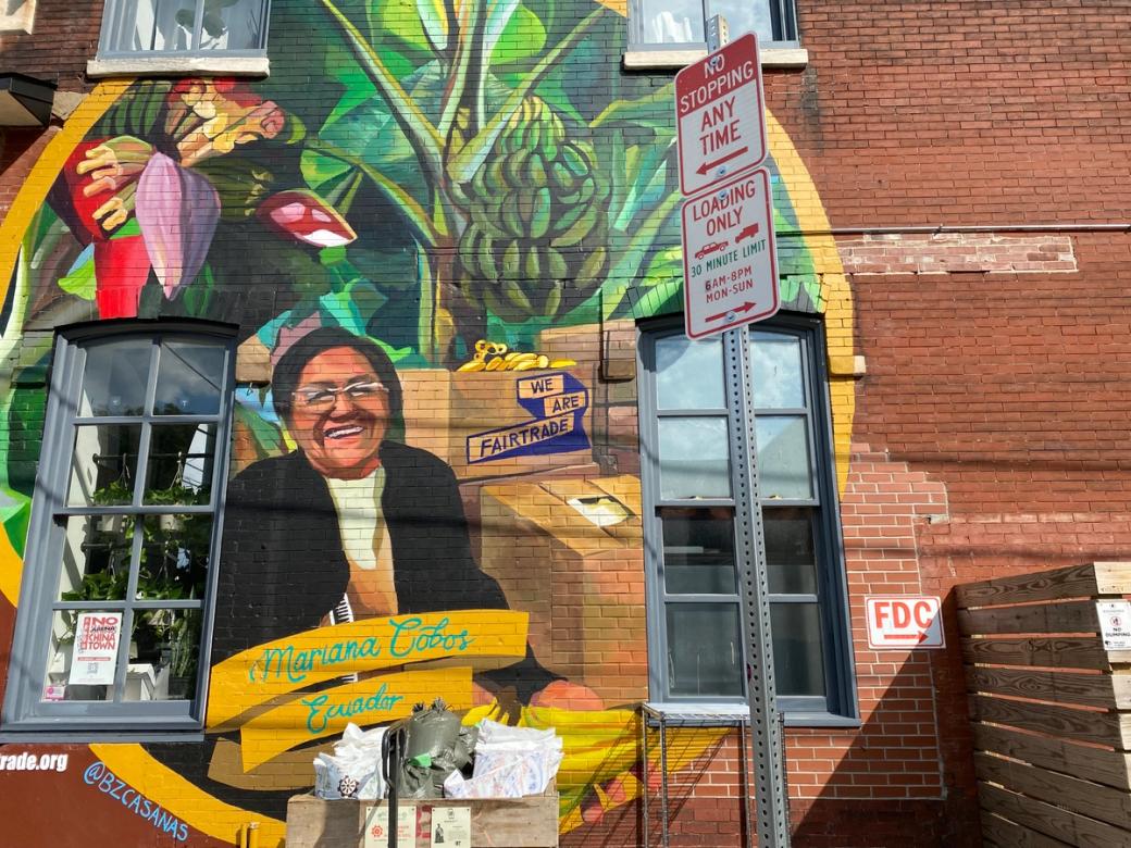 A mural on the side of a building of a woman named Mariana Cobos, from Ecuador.