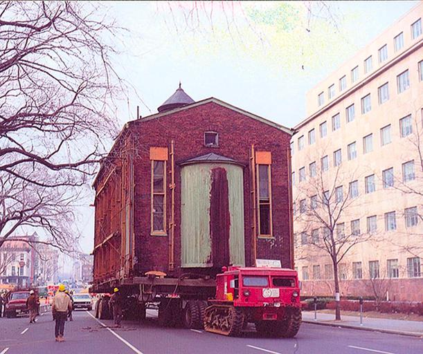 The first move of the historic 1876 Adas Israel synagogue building, in December 1969. Taken in front of the pension building along G St. Northwest. (Henry Brylawski/Capital Jewish Museum Collection)