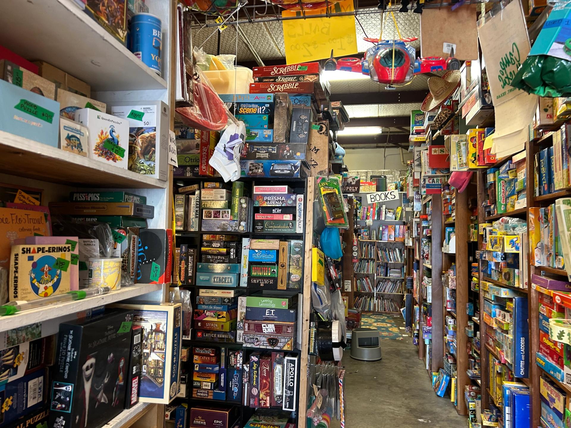 A store with shelves full of puzzles, games, and books.