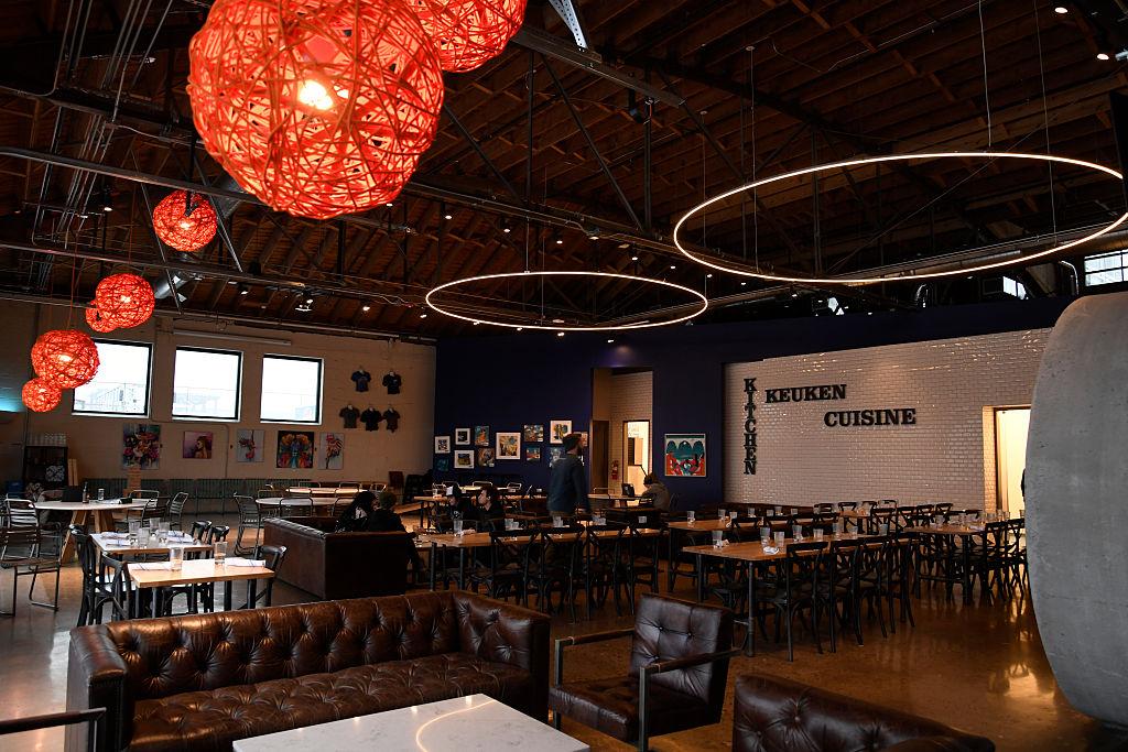 Brewpub interior with red lights on the ceiling and leather chairs