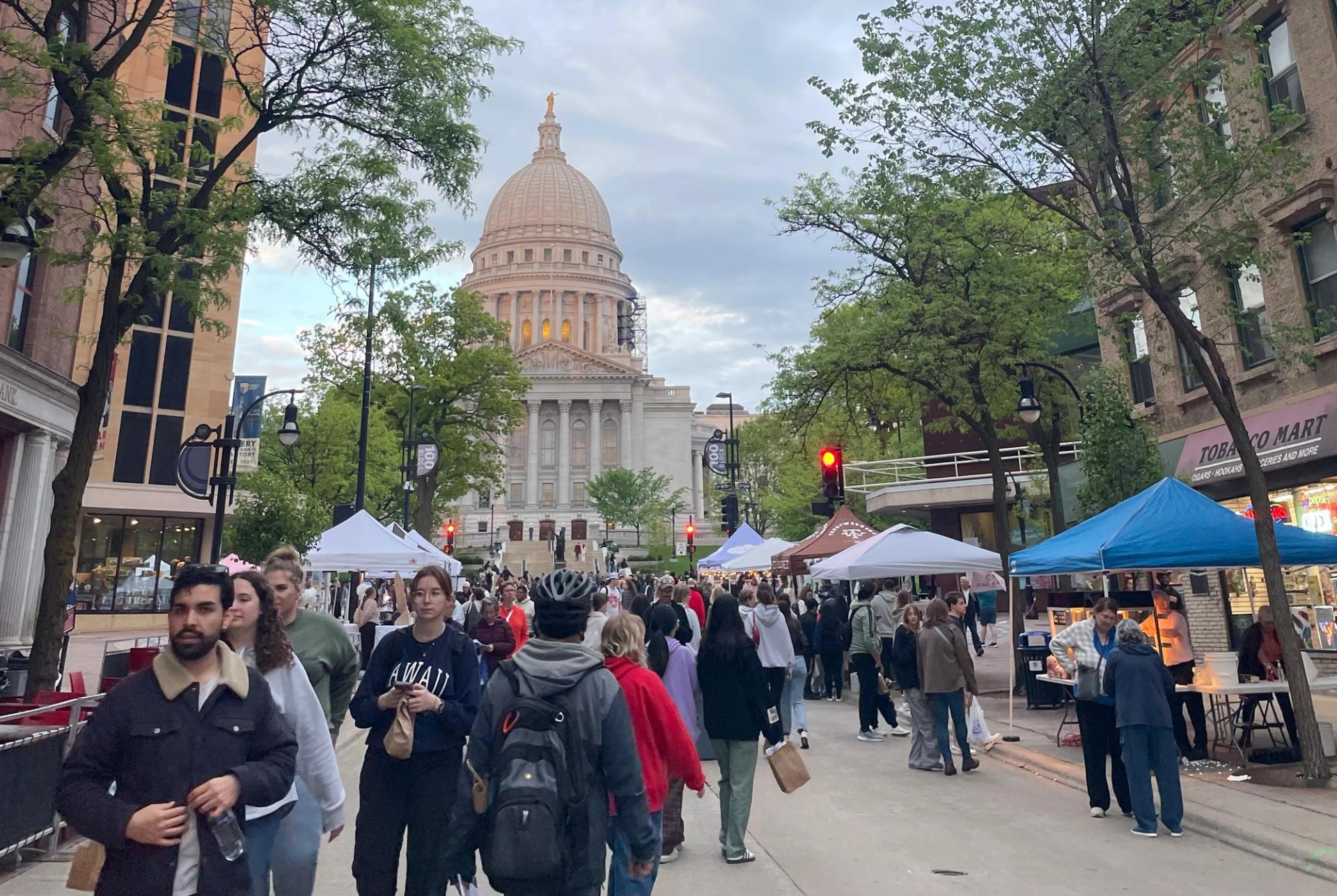 People walking on State Street at the Thursday night market.