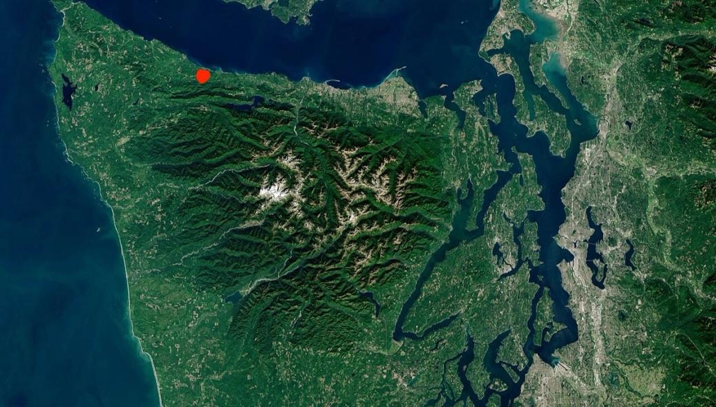 A satellite image of the North Olympic Peninsula with a red mark indicating the location of the Doc Holliday Timber Sale