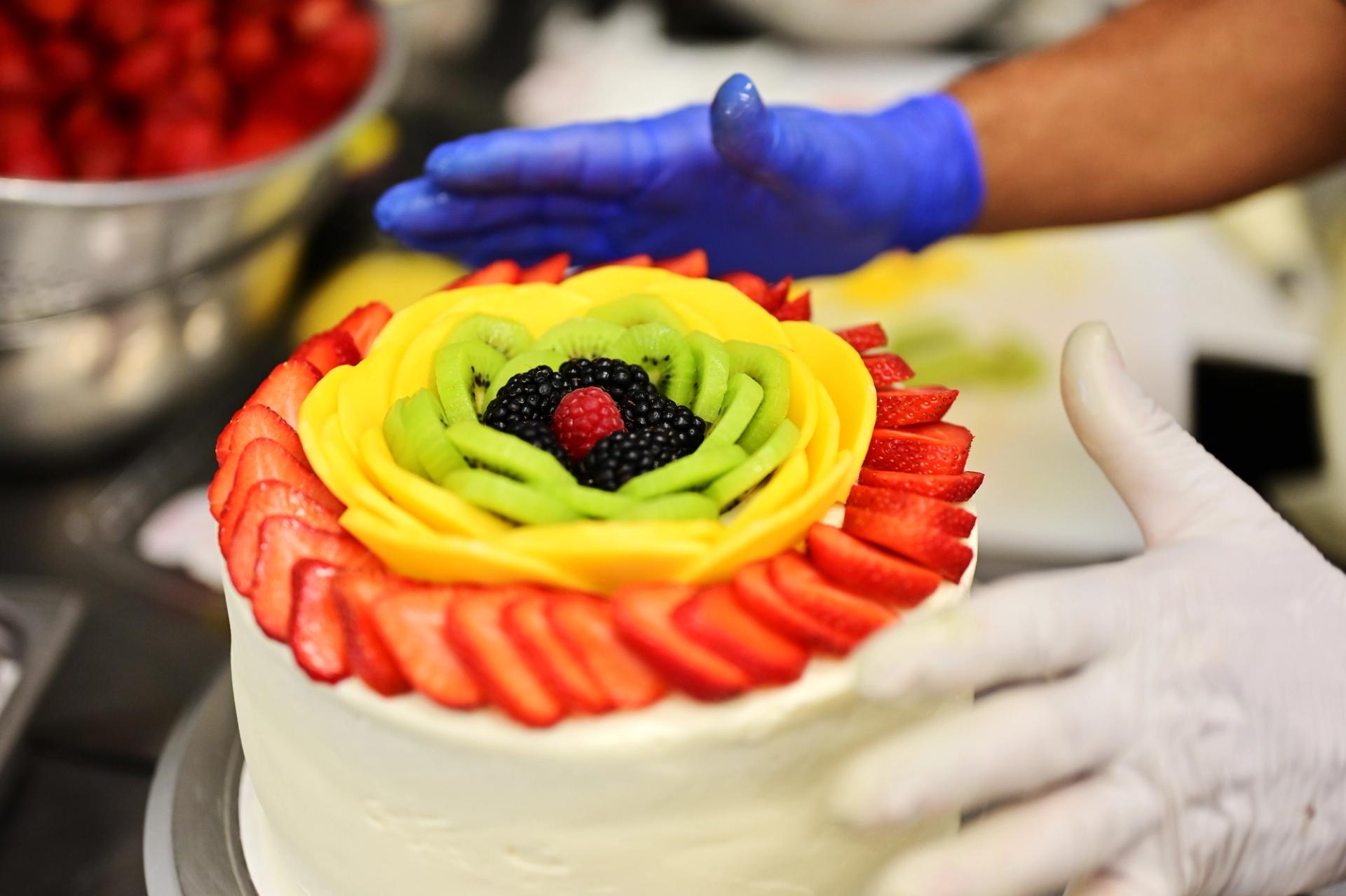A close up of the spring fling cake with a fruit pattern on top