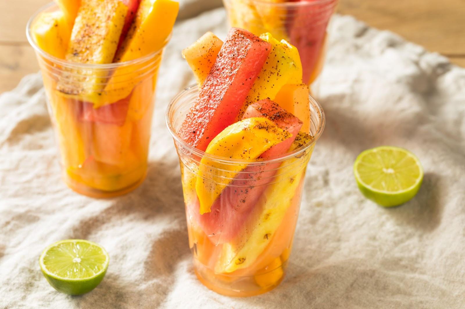 a cup of fruit sprinkled with tajin