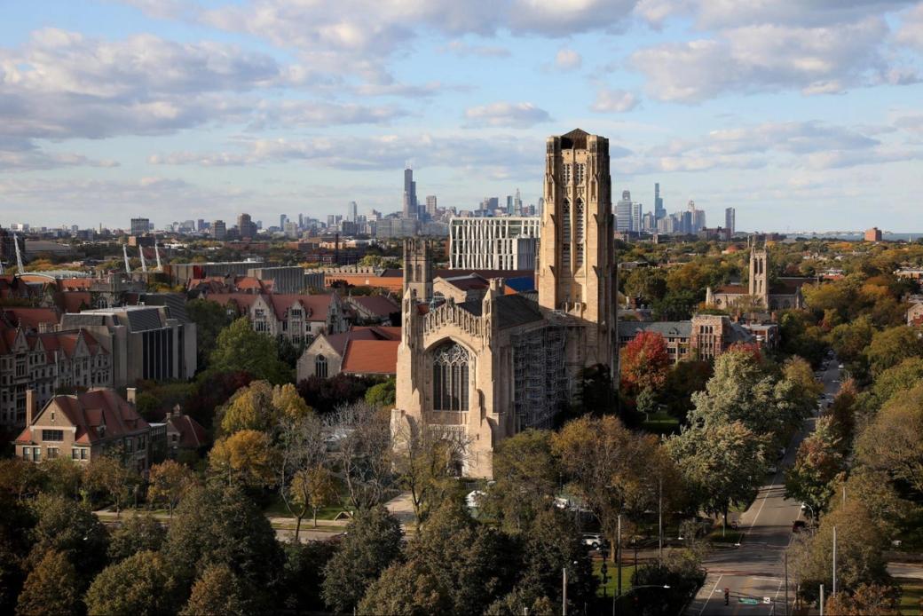 Rockefeller Chapel and University of Chicago buildings photographed from the 10th floor City View Room in the David Rubenstein Forum at the University of Chicago. Chicago skyline and other buildings and trees in the background.