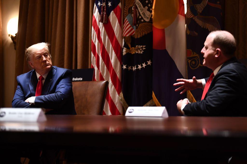 Two people sit at table discussing politics