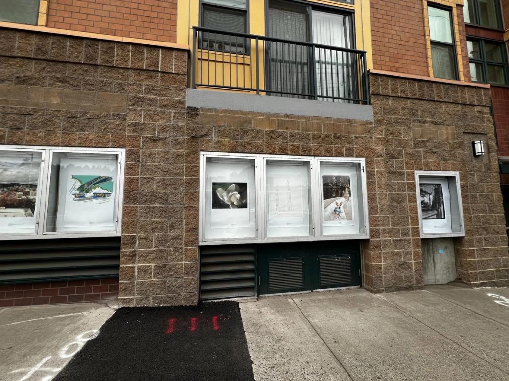 A wall of a building with art displays built into the stone.