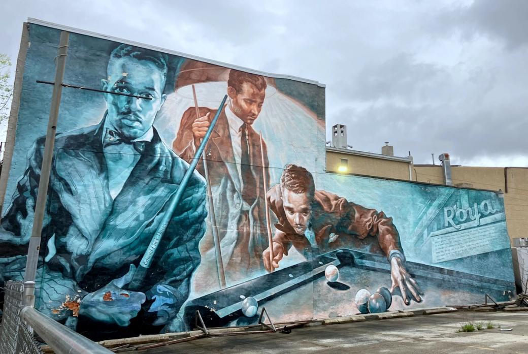 A mural of men playing billiards