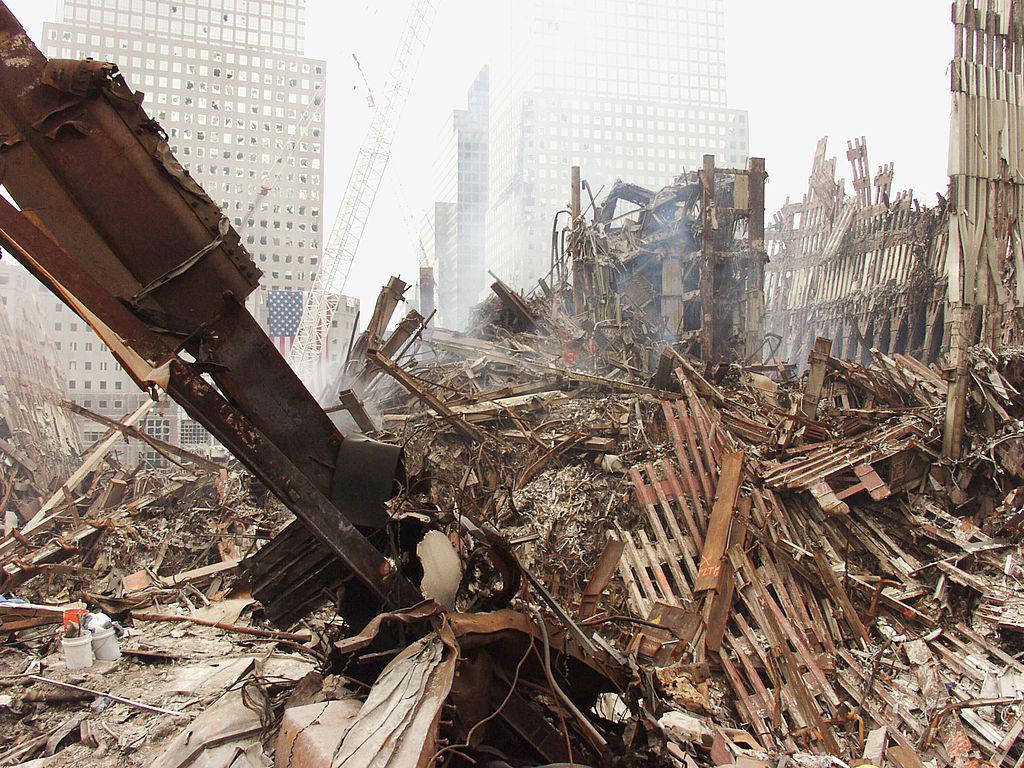 Wreckage after 9/11 is seen in piles while skyscrapers are visible in the distance