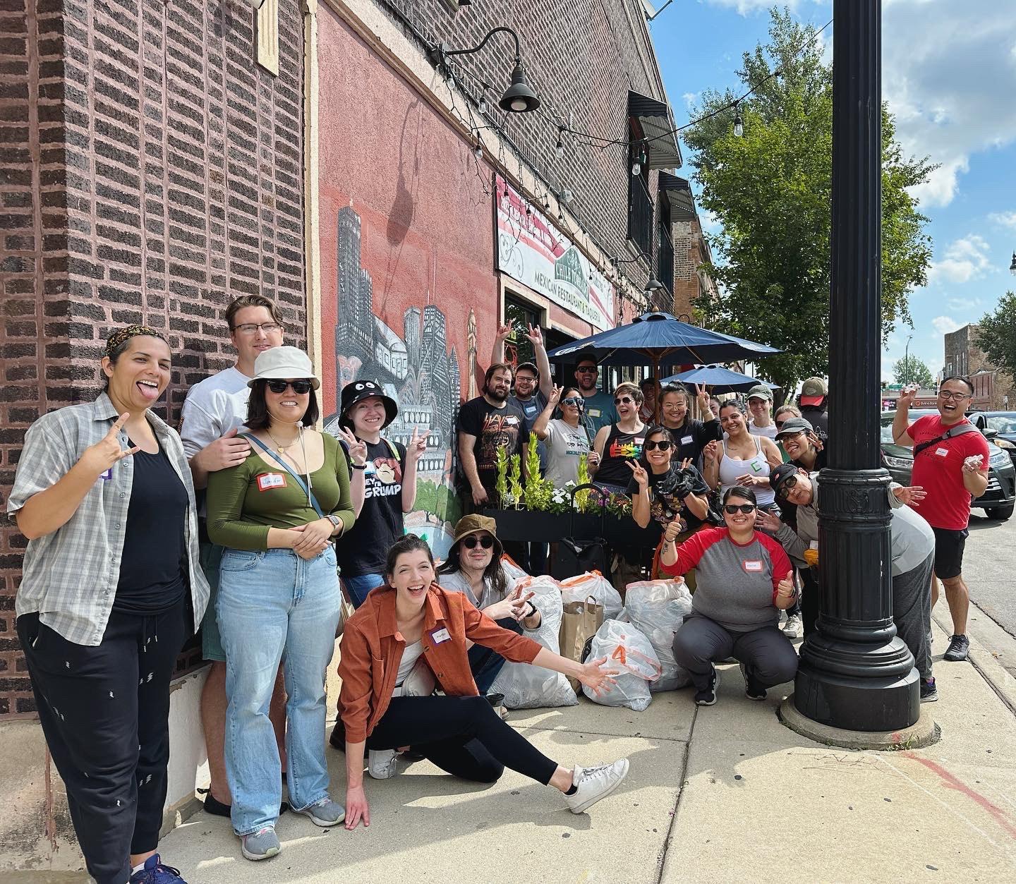 The Trash People of McKinley Park pose for a photo outside a restaurant.