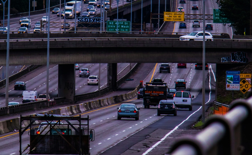 Traffic drives along I-5, including two tow trucks heading north bound.
