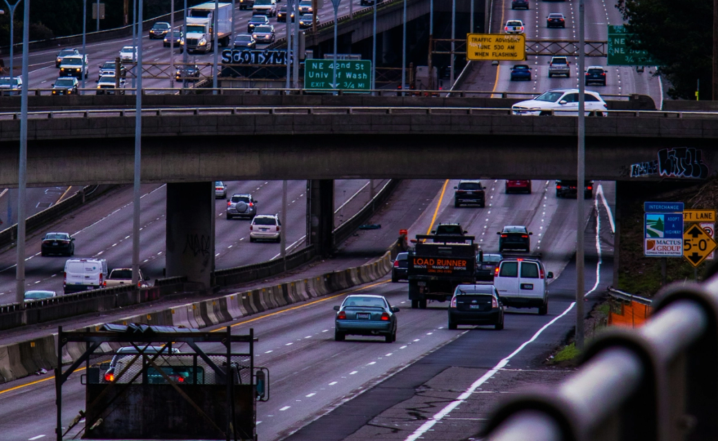 Traffic drives along I-5, including two tow trucks heading north bound.