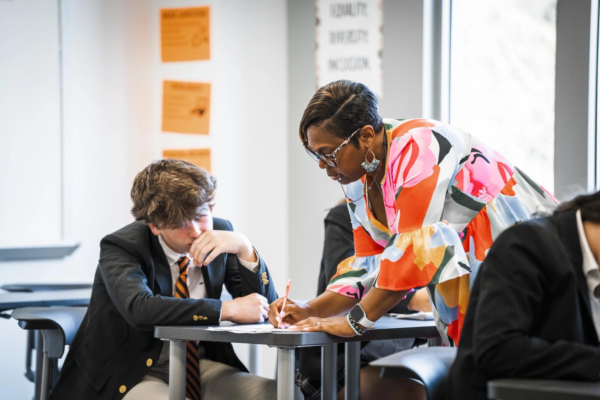 Teacher assisting student