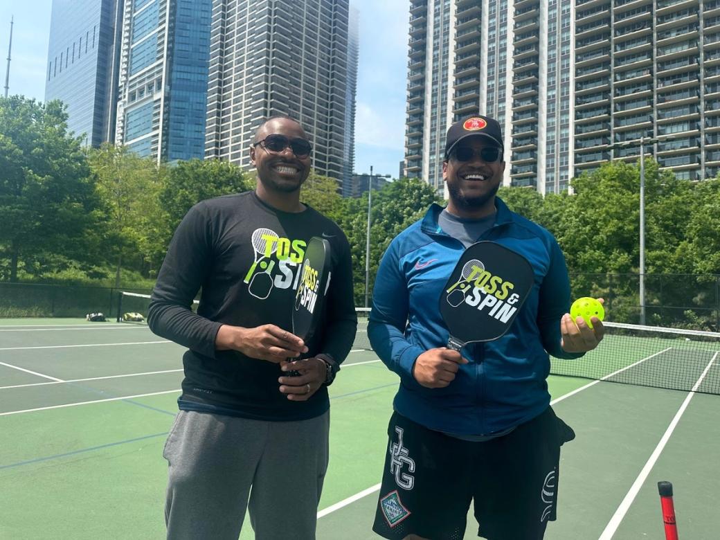 Two men standing in a tennis court in Chicago, Illinois.