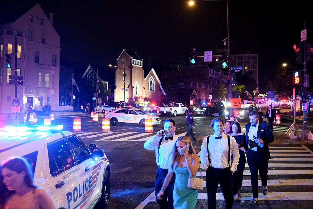 Guests walk away from the Washington Hilton after shots were heard during the White House Correspondents' Dinner. (