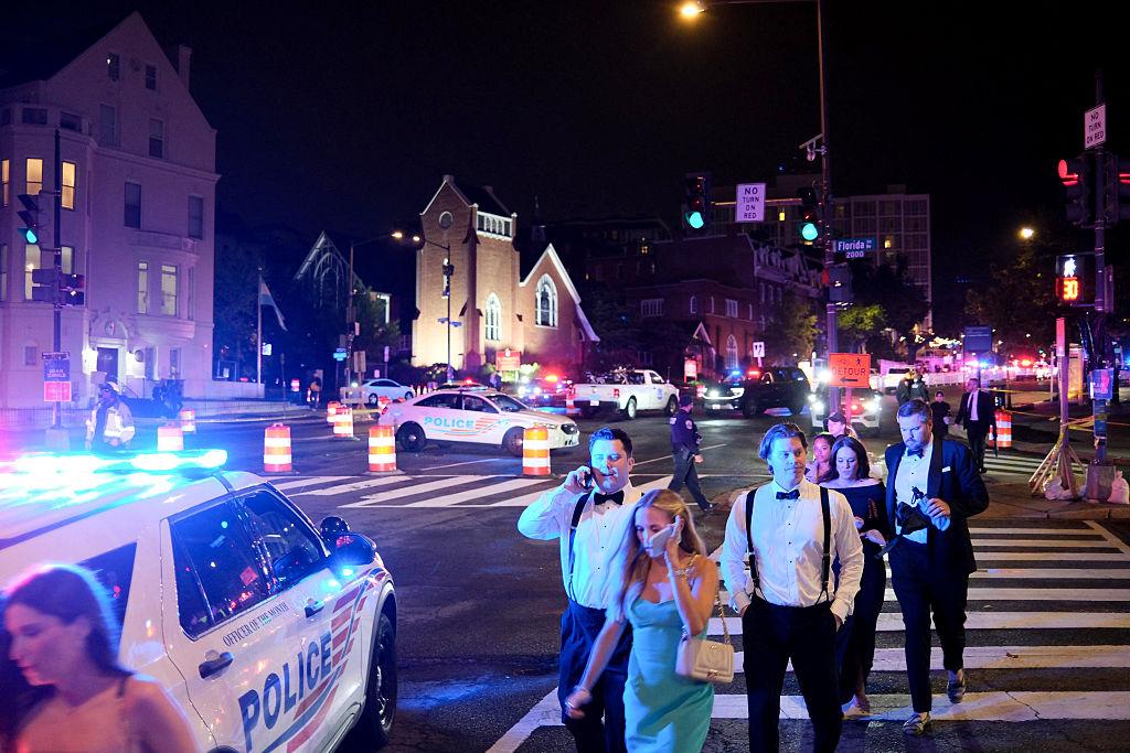 Guests walk away from the Washington Hilton after shots were heard during the White House Correspondents' Dinner. (