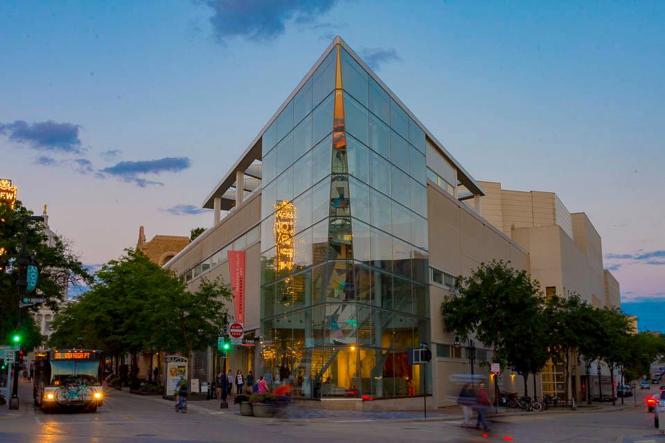 The glass walls of a museum look out over an intersection.