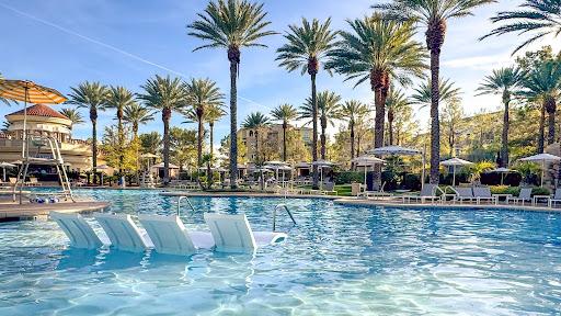 A pool with submerged lounge chairs.