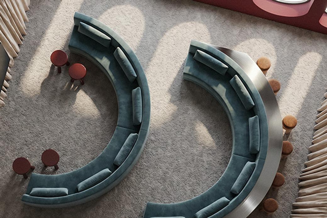 Curved teal couches face each other on a light carpet with round red side tables. Sunlight casts patterns, creating a calm, inviting atmosphere.