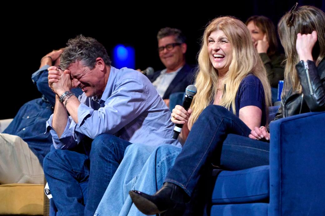 Kyle Chandler and Connie Britton laughing on a stage.