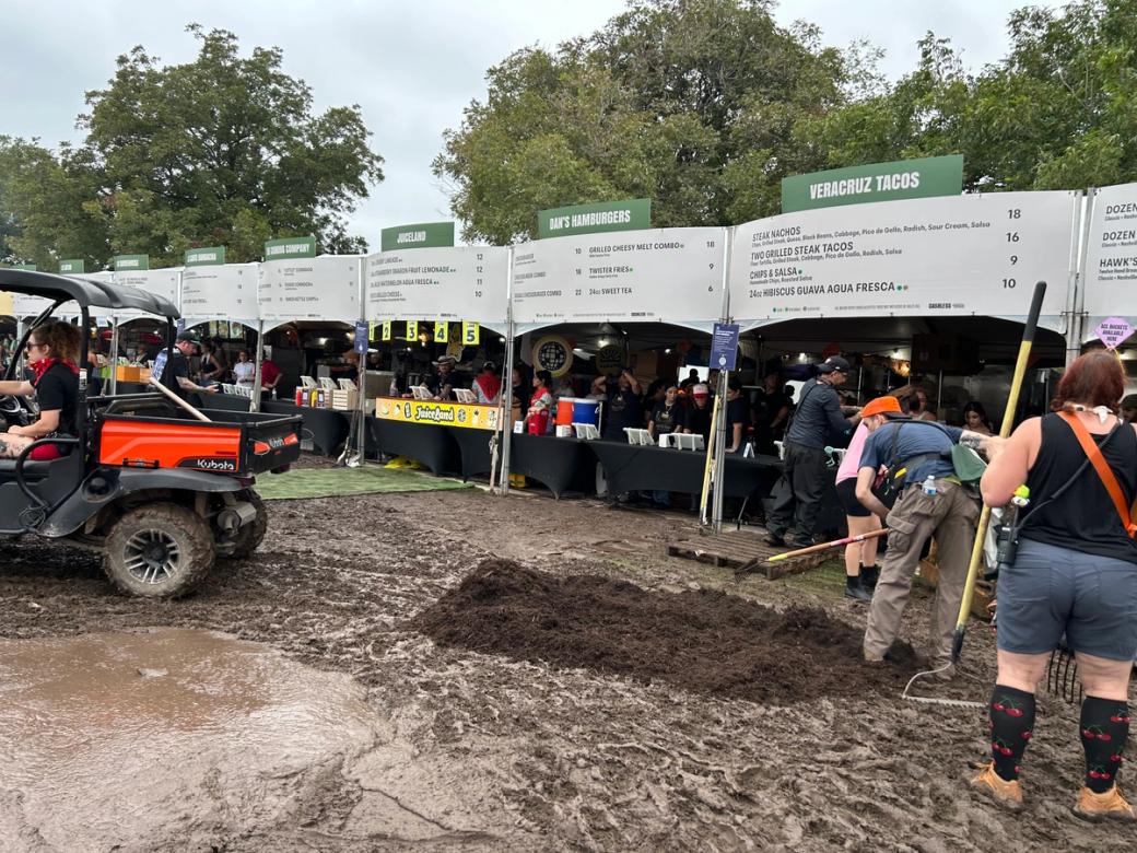 A person putting mulch on top of mud.