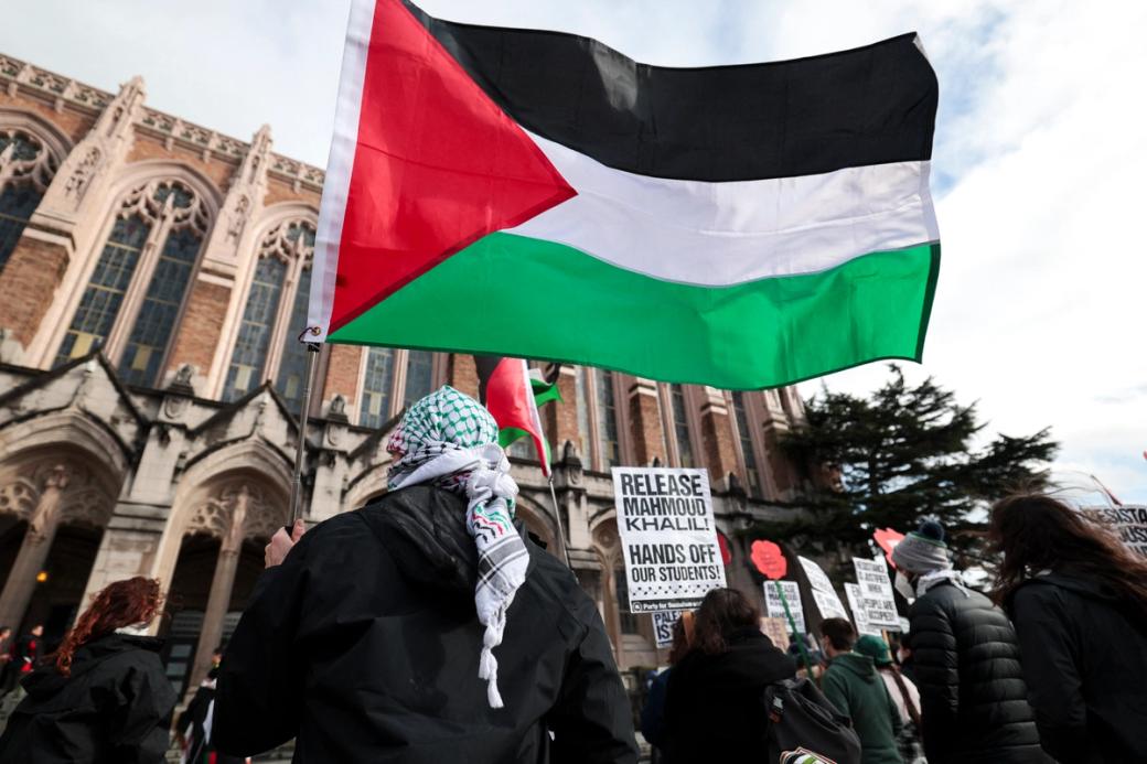 An image of protestors holding a Palestinian flag and ‘release Mahmoud Khalil’ signs in front of UW