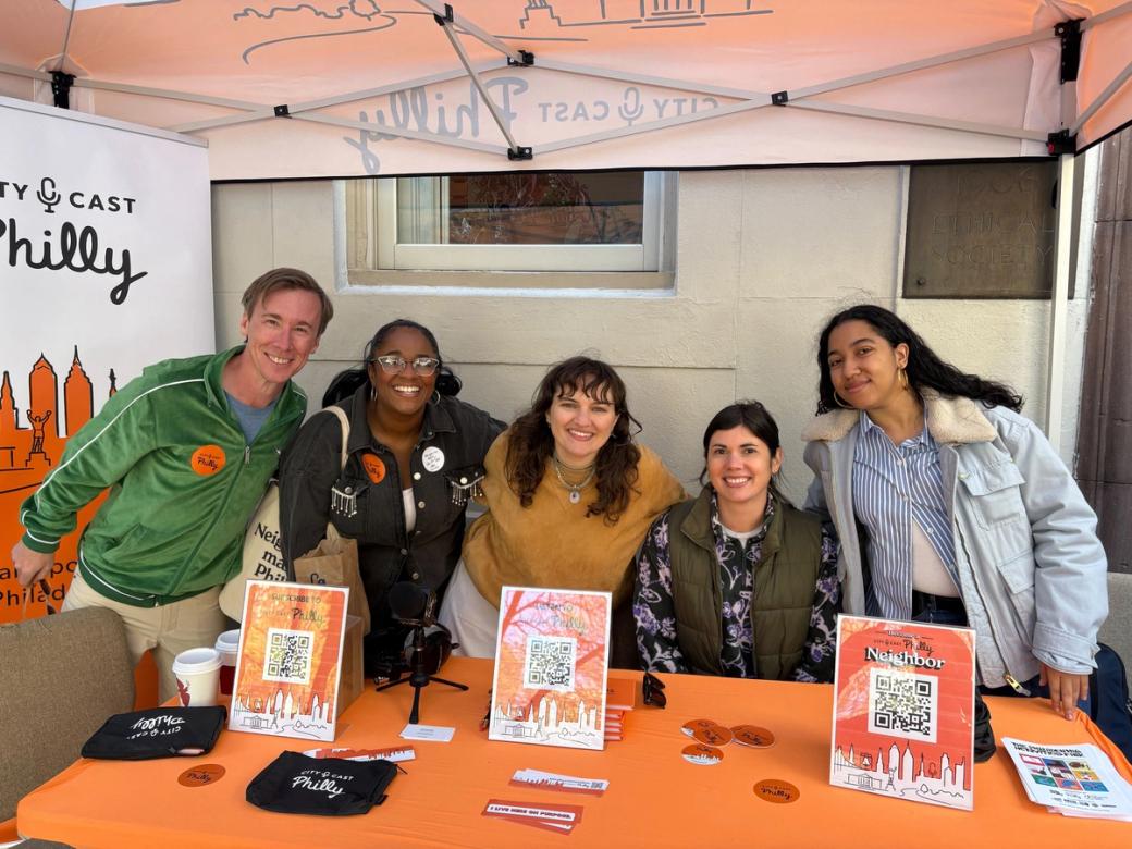 City Cast Philly team members pose for a photo at their table.