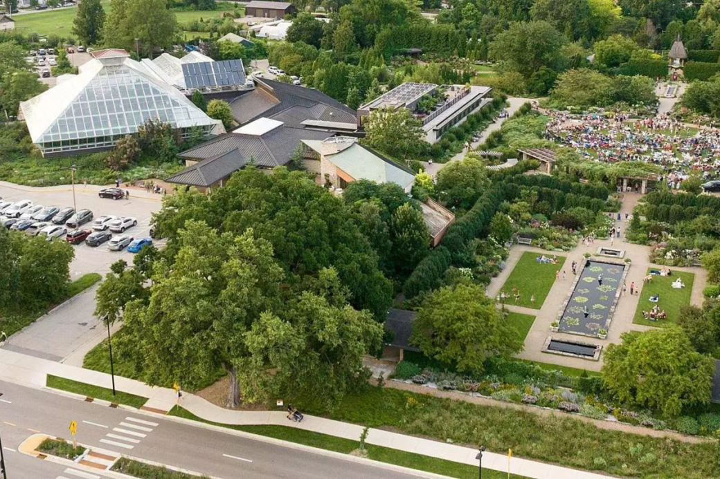 An aerial shot of a botanical garden with a parking lot.