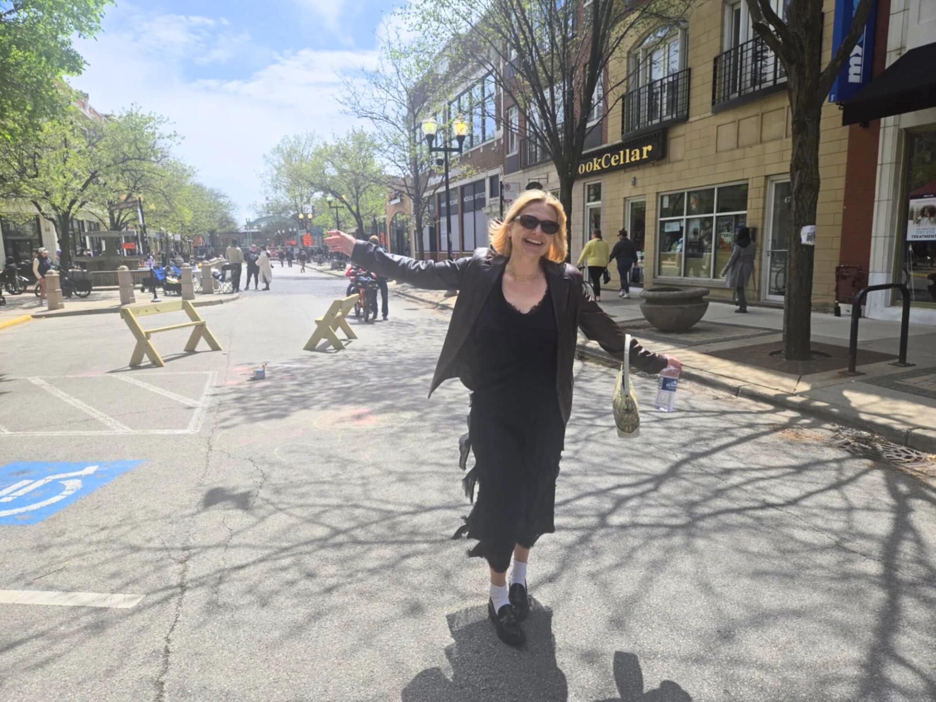 Walkability advocate Cori Dahl enjoys the recent road closure in Lincoln Square.