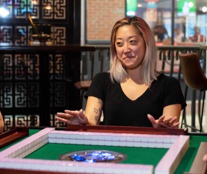 Nalee Kim playing Mahong while smiling