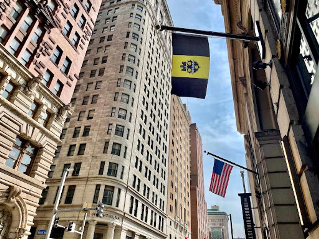 Pittsburgh flag and US flag hanging on a downtown street