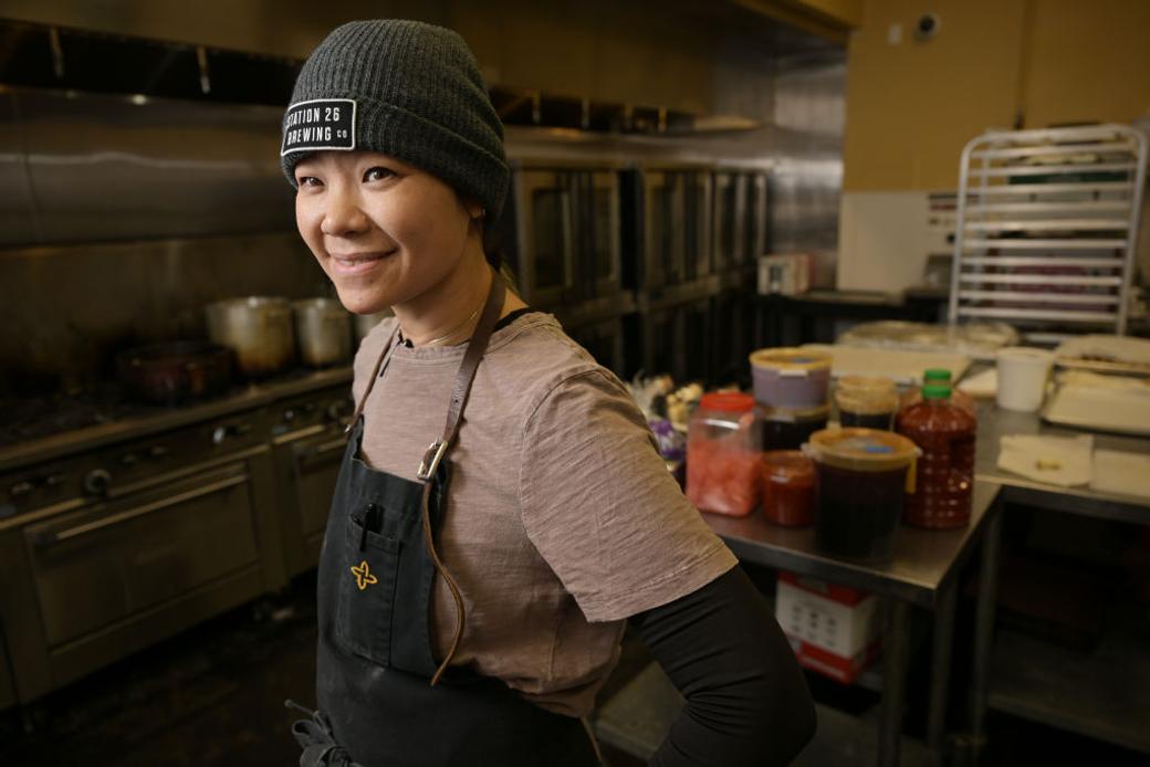 Chef poses in kitchen