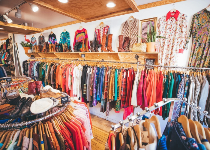 A store with racks of colorful clothes.