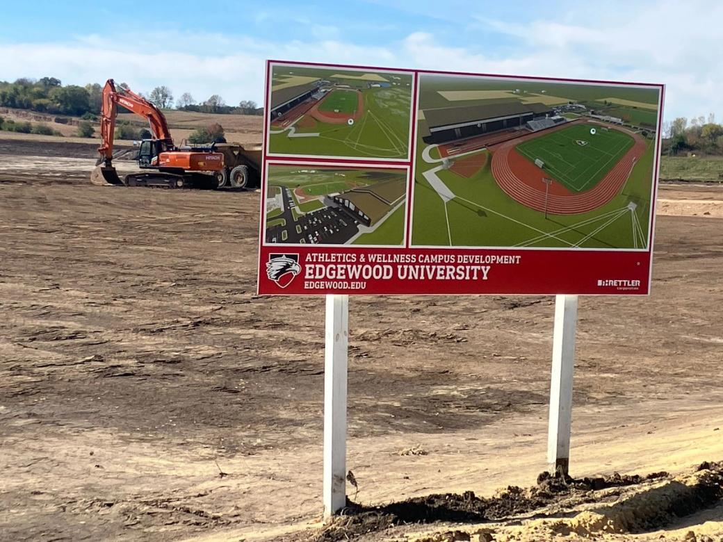 A construction site with a sign in front of it.