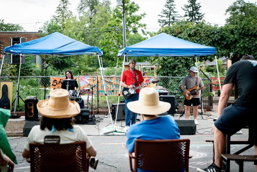 Musicians perform for a crowd at a neighborhood PorchFest.