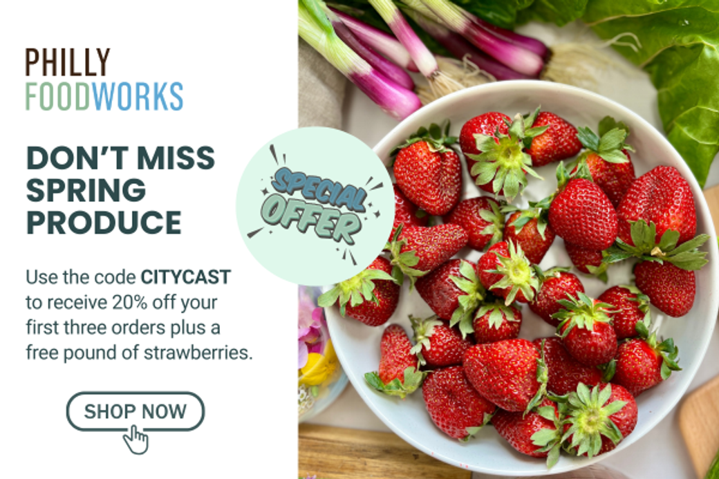 Alt text: "Philly Foodworks ad showcasing a bowl of fresh strawberries on a table with assorted produce. Text offers 20% off and free strawberries with code CITYCAST."