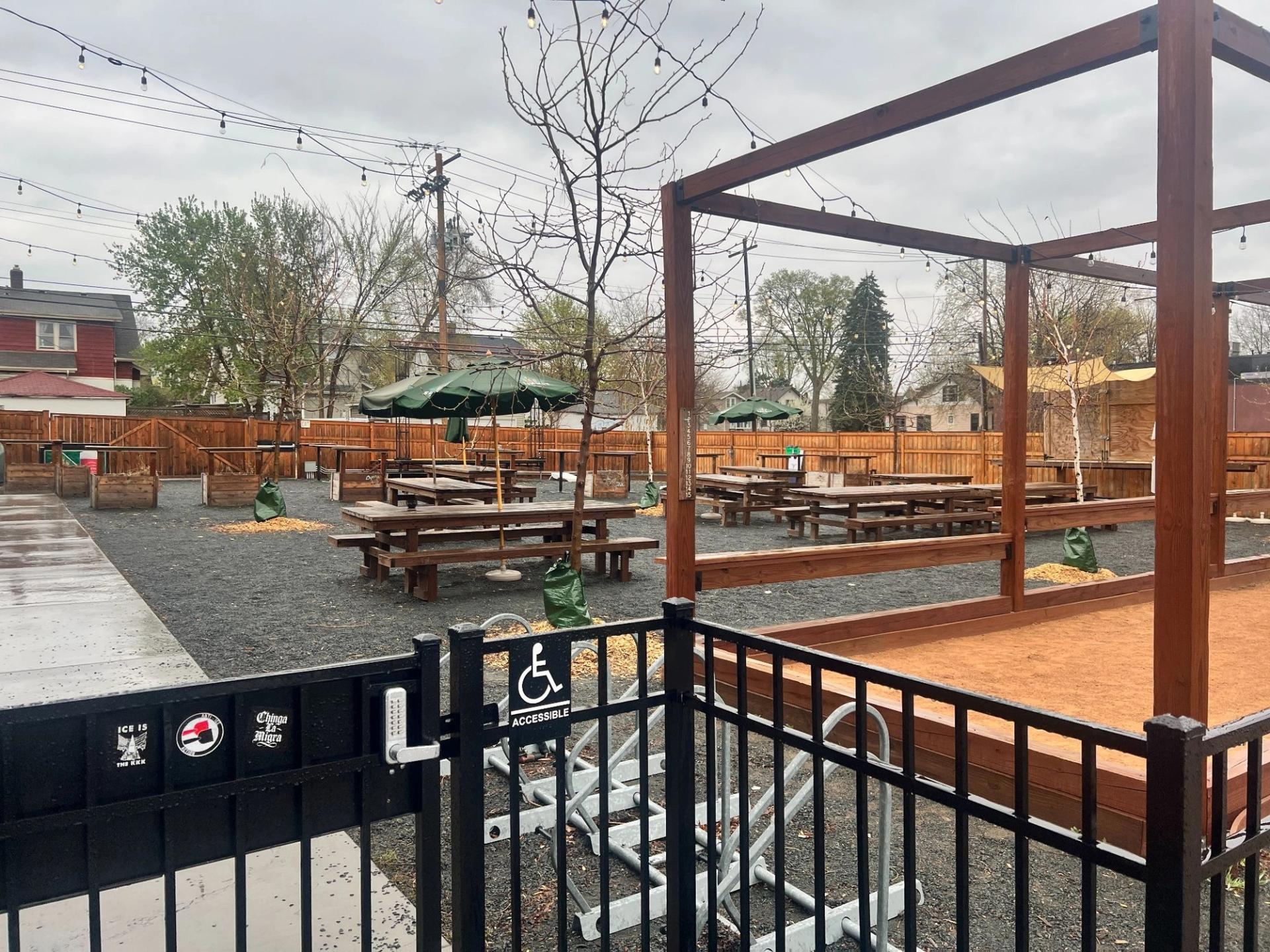 A patio of an establishment with tables and umbrellas