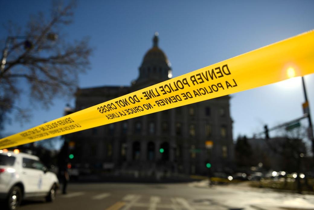 Police tape crosses a street in Denver